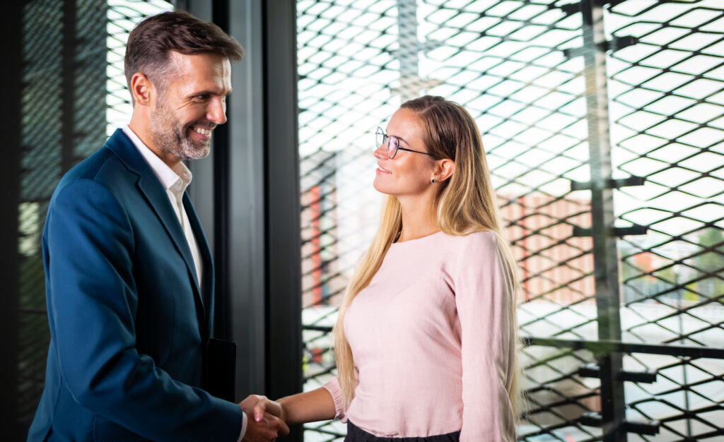 Business people shaking hands in the modern office finishing successful meeting